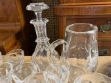 many glasses and a decanter sitting on a table