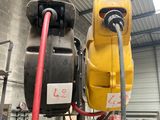 a picture of a yellow and black machine in a garage