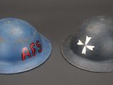 two helmets that are sitting side by side on a table