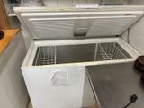 a white chest freezer sitting in a kitchen next to a counter