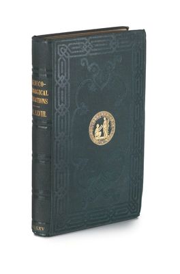 an old book with a gold emblem on the front cover