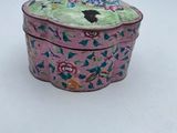 an image of a pink box with flowers on it on a white surface