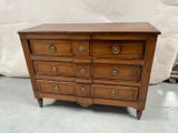 an old wooden dresser with four drawers and brass pulls