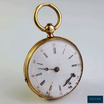 une montre de poche en or avec des chiffres romains sur le cadran