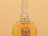 a small glass bottle with a picture of jesus on it