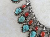 an image of a necklace with turquoise and red stones on it