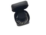 black leather jewelry box with a chain around it on a white background