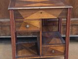 a small wooden table with two drawers on top of it