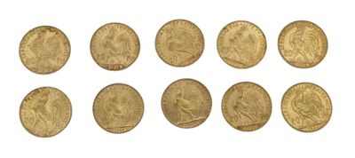a close up of a bunch of gold coins on a white surface