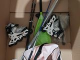 a box with a bunch of skis and ski poles in it