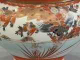 a large vase with a lid that has flowers and birds on it