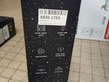 a black box with a barcode on it sitting on a tiled floor