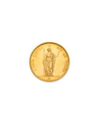 Gros plan sur une pièce d'or ornée d'une statue