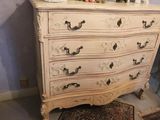 a dresser with a mirror on top of it in a room