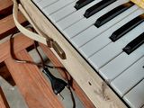 a close up of a keyboard on a wooden bench