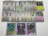 a lot of different pokemon cards on the table