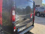 the back end of a black van parked in a parking lot