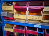 many bins of assorted items on a shelf