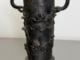 a black vase sitting on top of a table