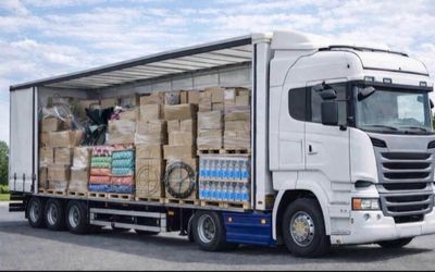 a truck with a trailer full of boxes on the back