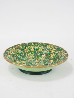 an image of a green and yellow bowl with flowers on it