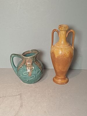 two vases sitting next to each other on a table