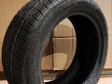 a close up of a tire on a cardboard box with a cardboard box in the background