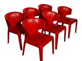 six chaises rouges sont alignées en rangée sur un fond blanc