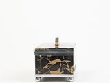 a black and gold marble box sitting on top of a white surface