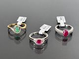 three different colored stones are displayed on a black surface