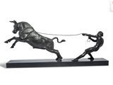 statue of a man pulling a bull with a rope