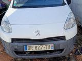 a small white car parked in front of a building
