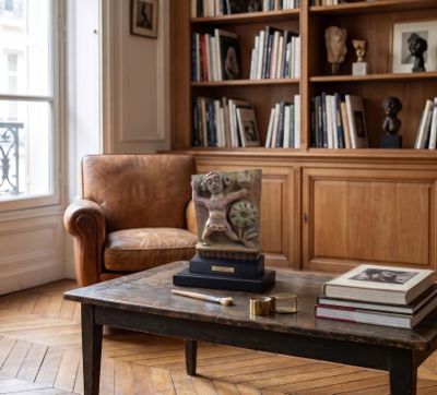 a coffee table with books on top of it in a living room