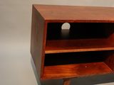 a small tv stand with a wooden shelf on it