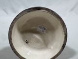 a close up of a vase with a tag on it