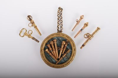a gold locke with a bunch of keys hanging from it
