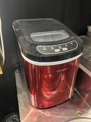 a red toaster sitting on top of a kitchen counter