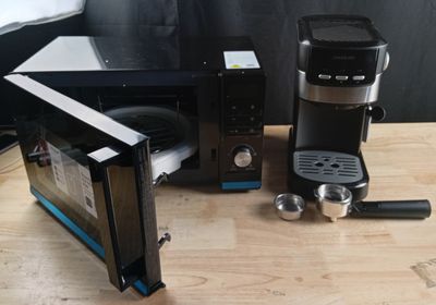 a microwave and a coffee maker sitting on a table