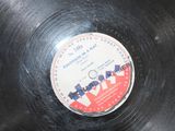 a black record with a red and white label on it