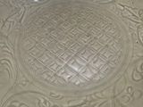 a white plate with a design on it on a table