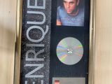 a picture of a framed picture of a man with a cd in it
