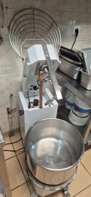 an image of a kitchen with a mixer and a bowl on the floor