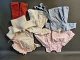 four pairs of panties are lined up on a black surface