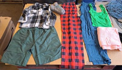 several pieces of clothing are laid out on a table in a room