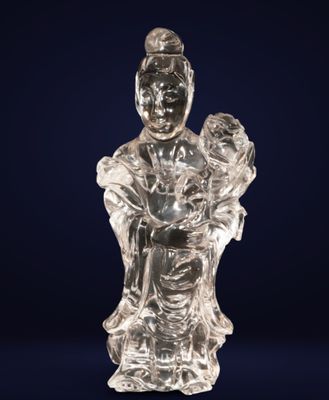 a glass figurine of a woman holding a child