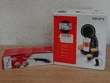 packaging of a coffee machine sitting on top of a table next to a box