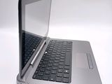 a silver laptop with a black keyboard on a white surface