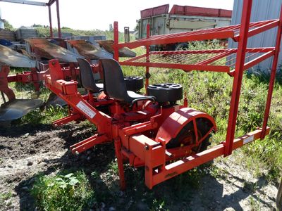 a red machine that is sitting in the grass