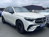 a white mercedes suv parked in a parking lot next to other cars
