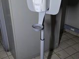 a toilet in a public restroom with a sign on it